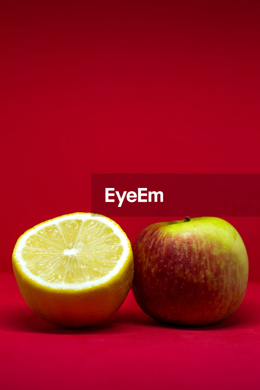 Close-up of fruits against orange background