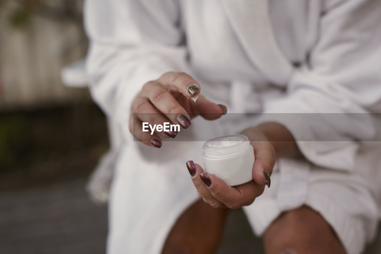 Woman's hands holding moisturizer