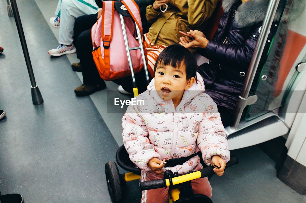 PORTRAIT OF CUTE GIRL SITTING IN CAR