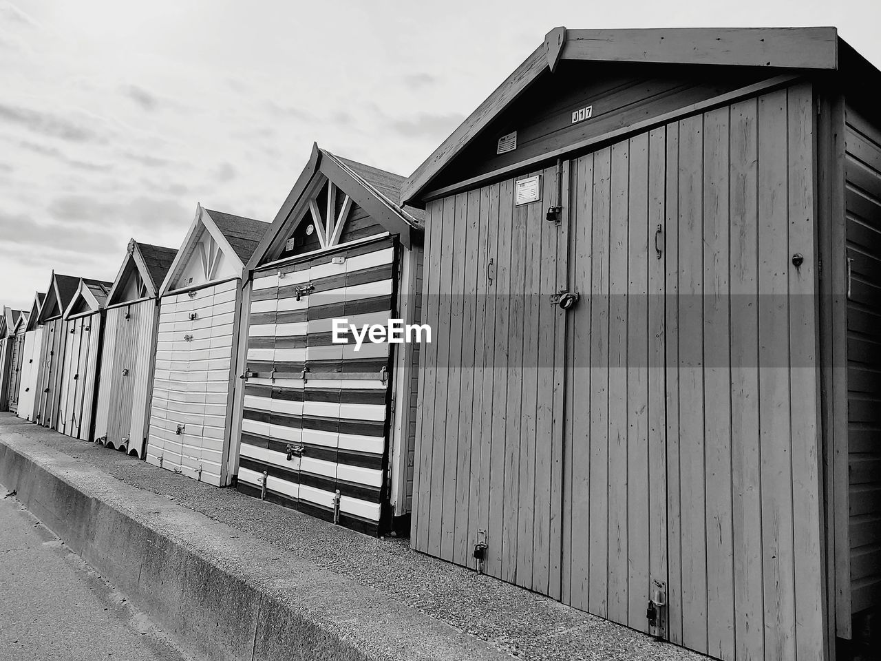 View of beach huts by building against sky