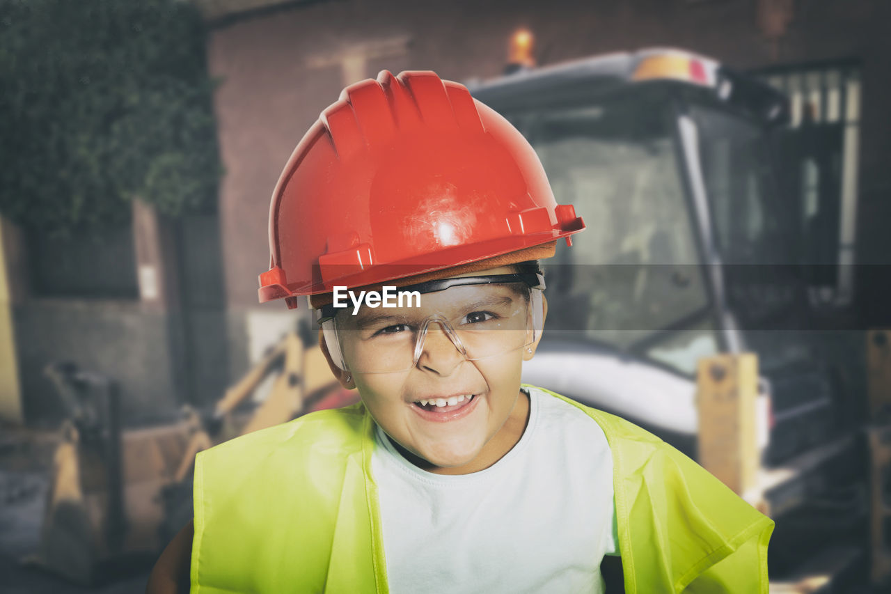 Portrait of smiling boy standing at construction site