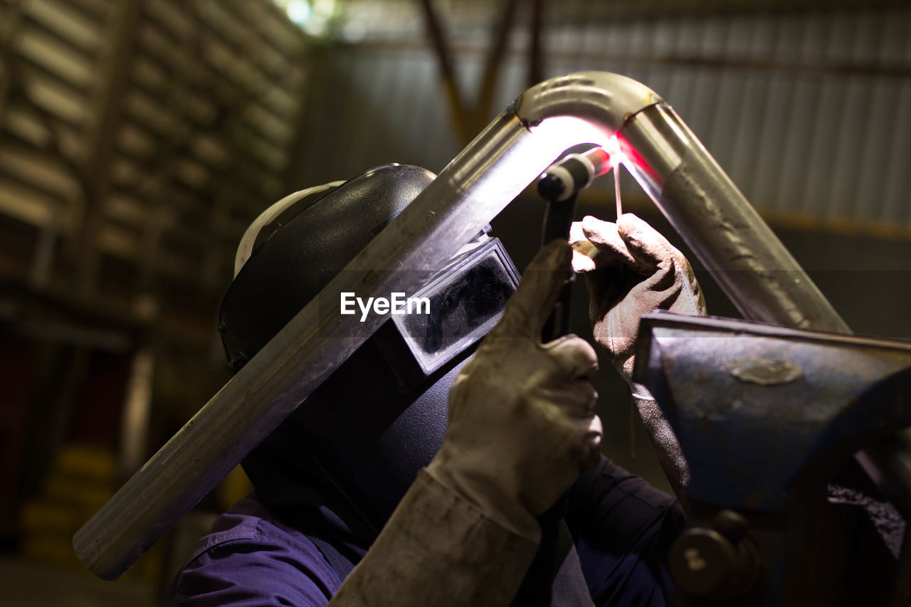 Welder welding in workshop