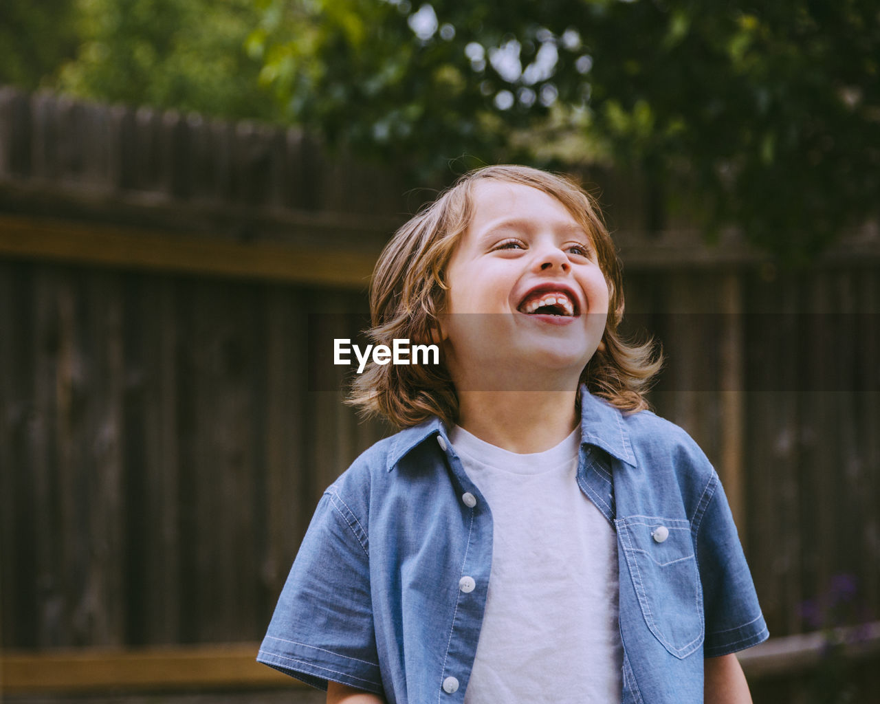 Cute boy laughing in back yard