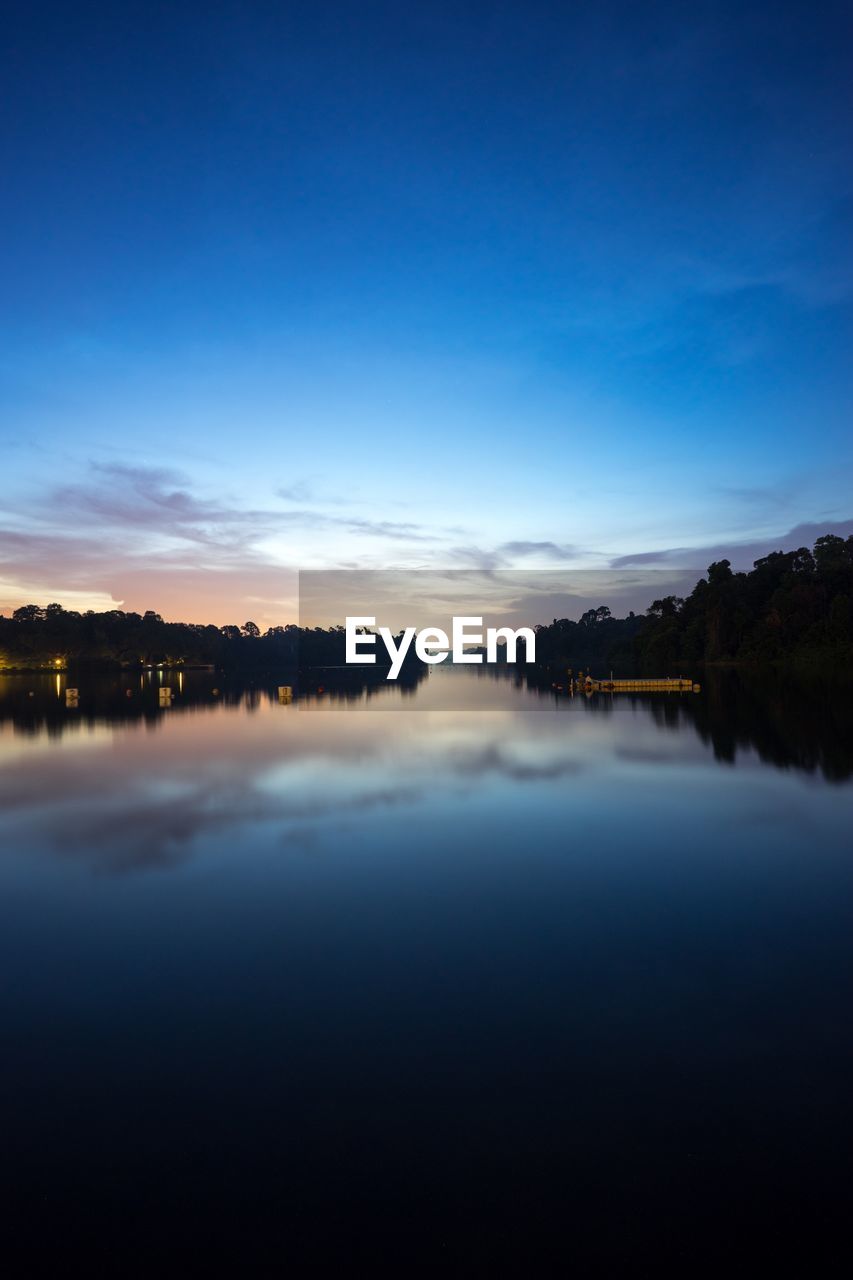 Scenic view of lake against blue sky