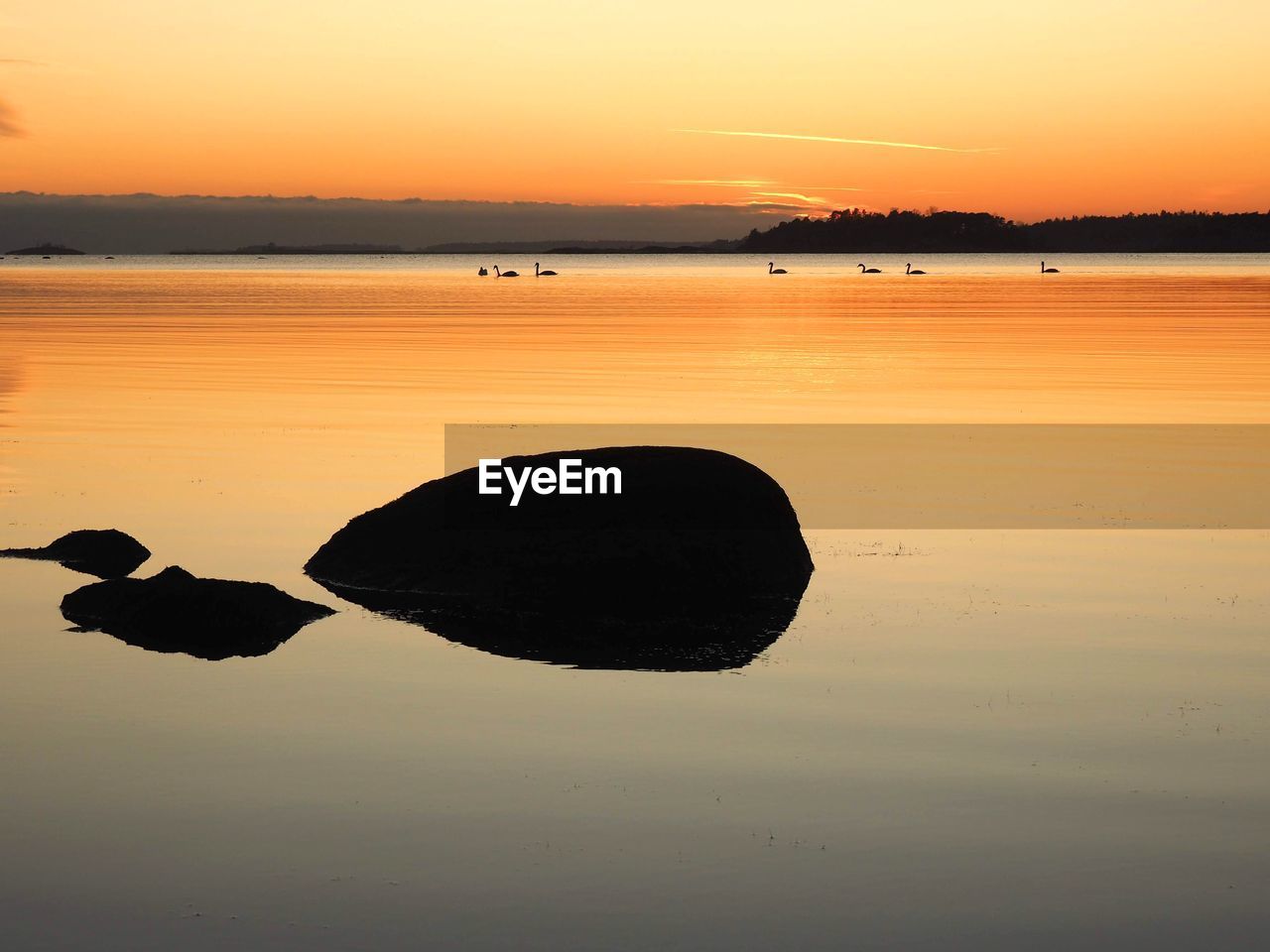 Scenic view of lake against sky during sunset