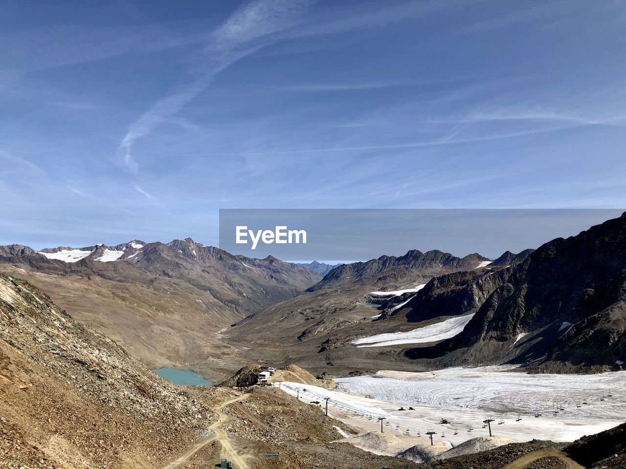 Scenic view of mountains against blue sky