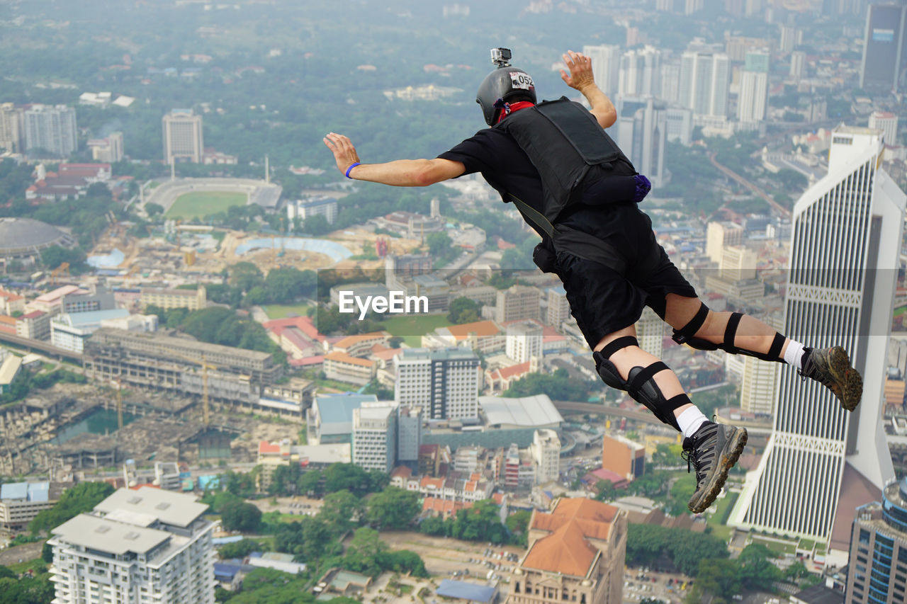 Skydiver over cityscape