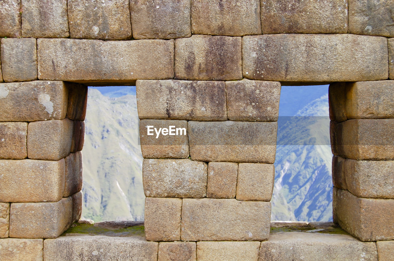 VIEW OF STONE WALL OF BUILDING WITH BRICK WALLS