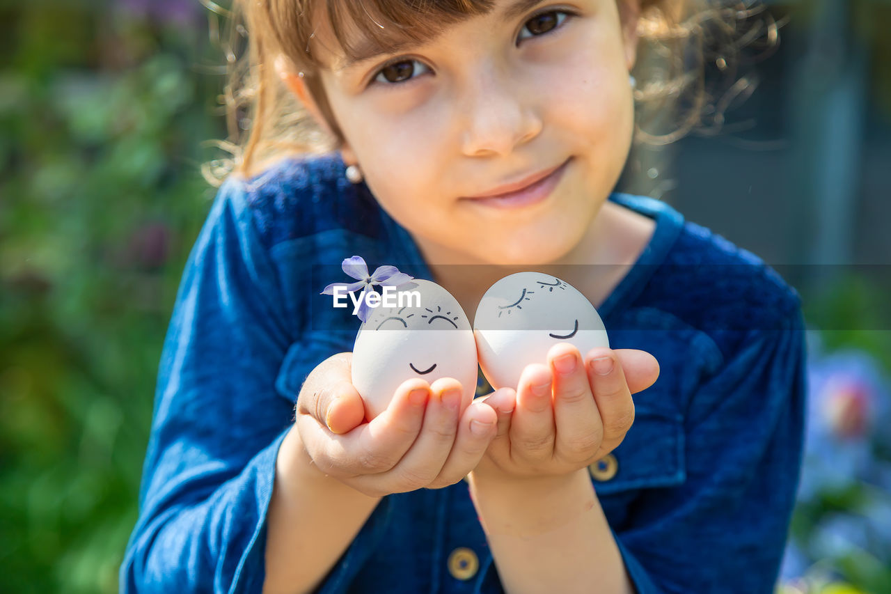 Cute girl holding easter eggs