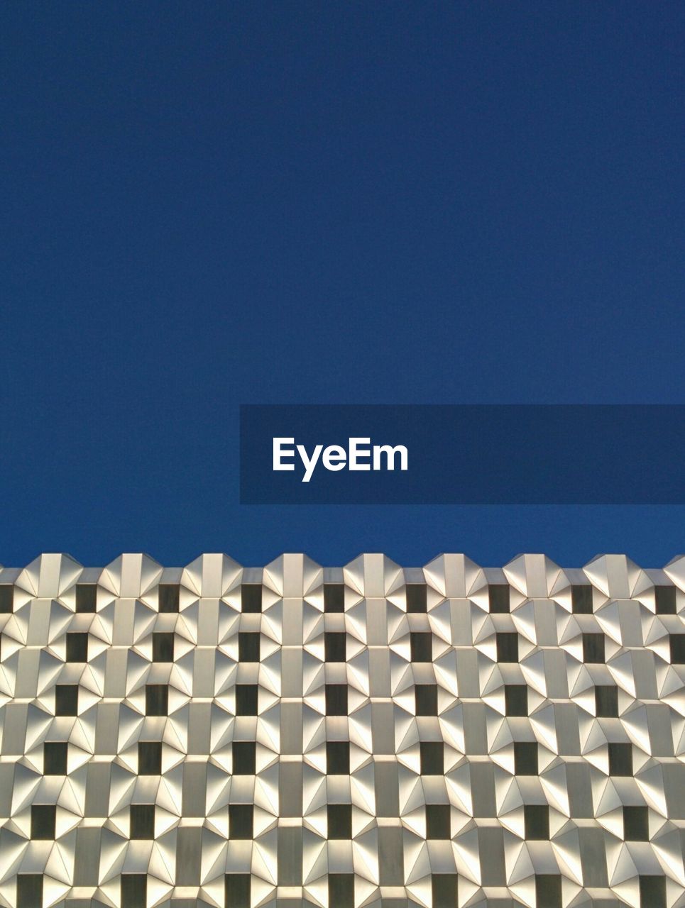 Low angle view of centrum-galerie against clear blue sky