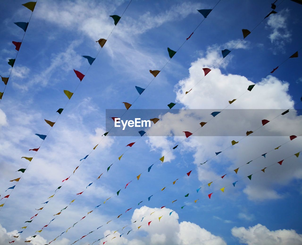 Low angle view of buntings against sky