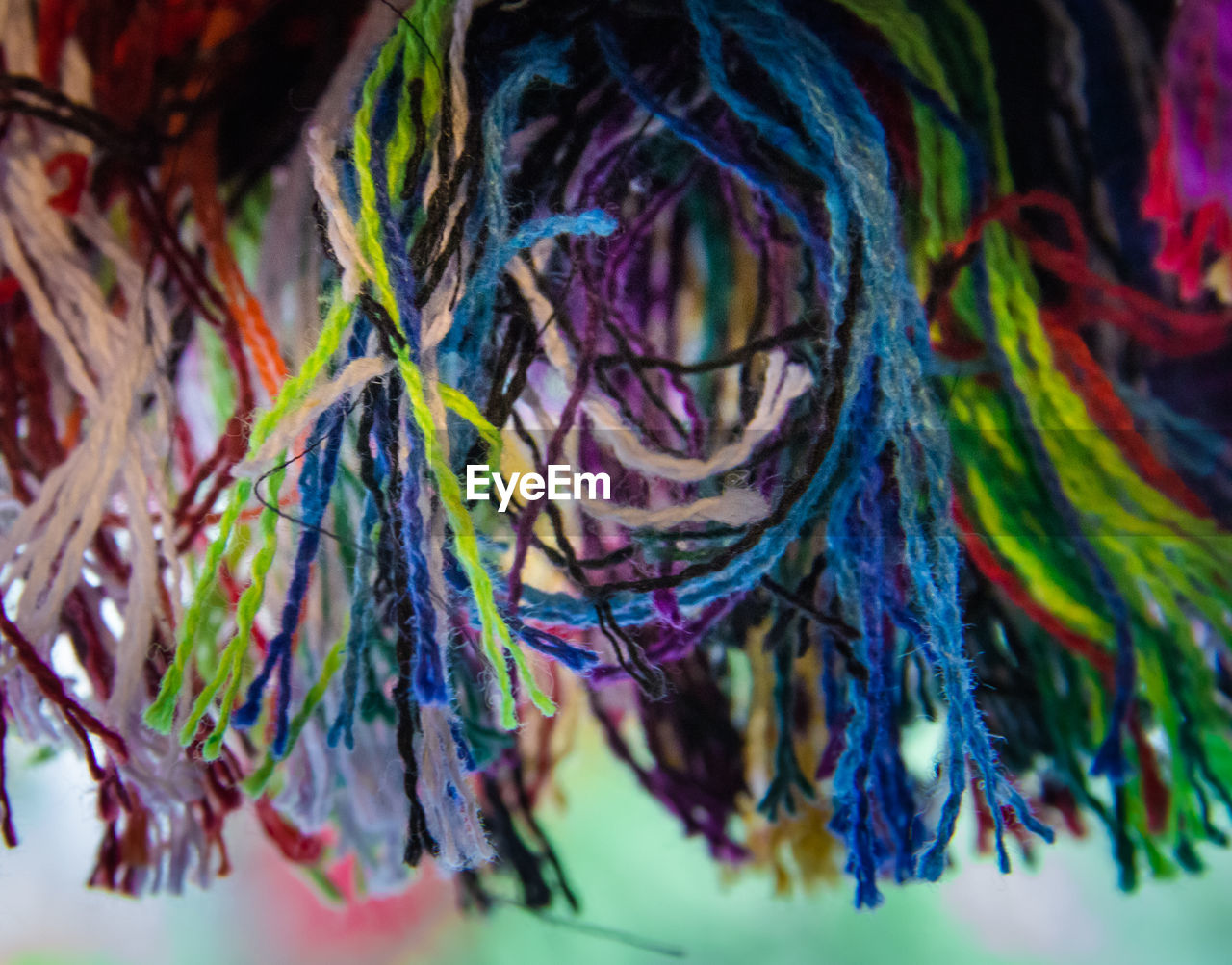 Full frame shot of colorful threads hanging in the local shop for sale