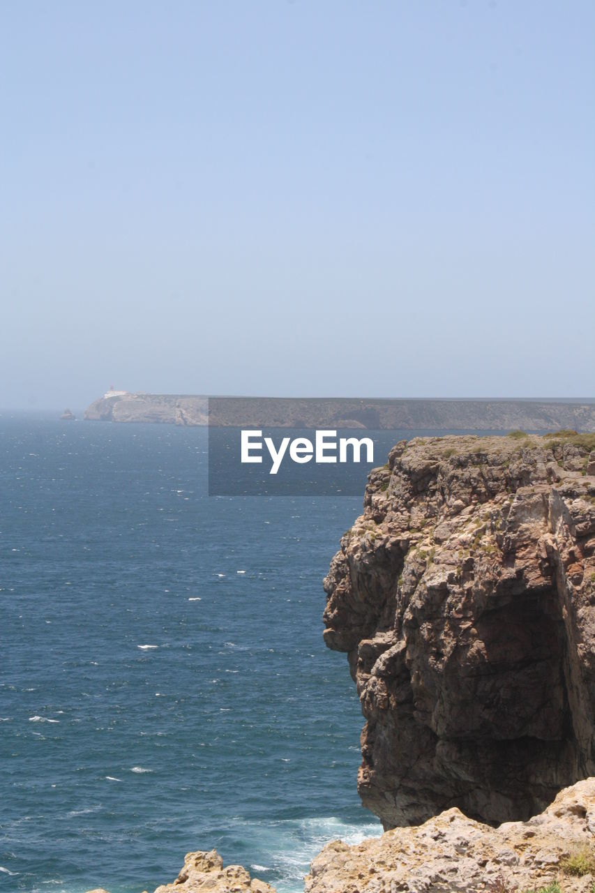 SCENIC VIEW OF SEA WITH ROCKS IN BACKGROUND