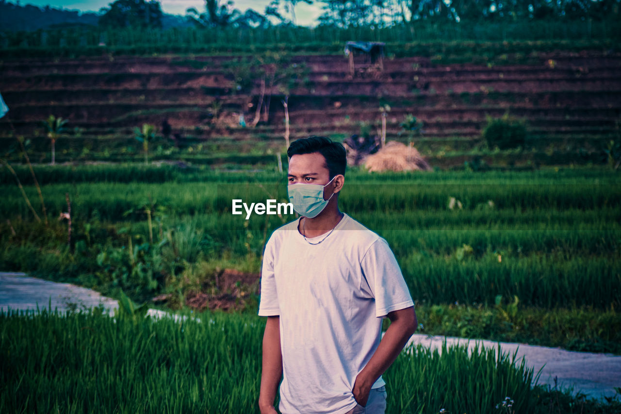 FULL LENGTH OF YOUNG MAN STANDING ON LAND