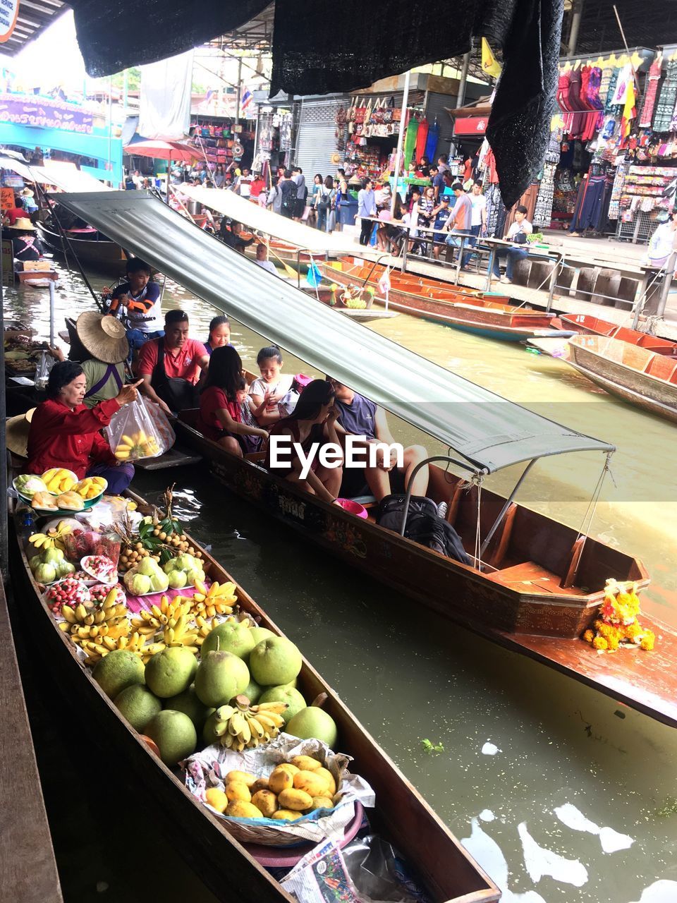 HIGH ANGLE VIEW OF PEOPLE AT MARKET STALL IN CITY