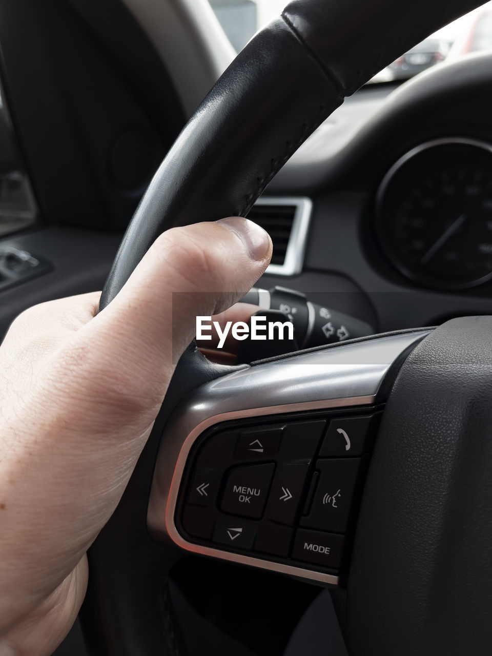 cropped hands of man using car