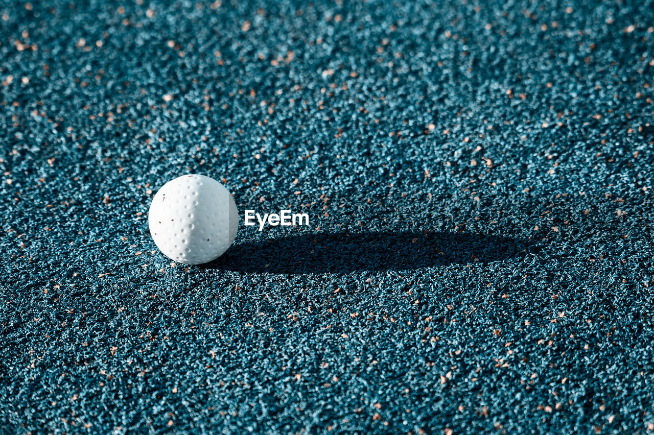 Close-up of golf ball on ground