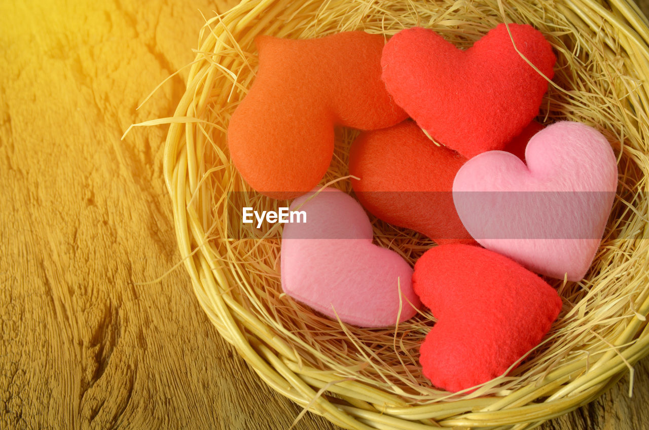 High angle view of heart shape decorations in bird nest on table