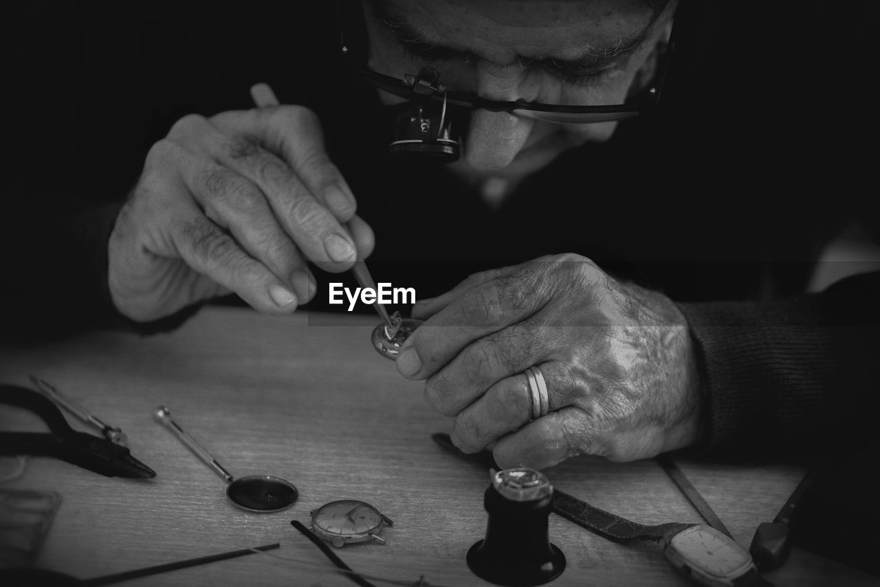 Man fixing pocket watch