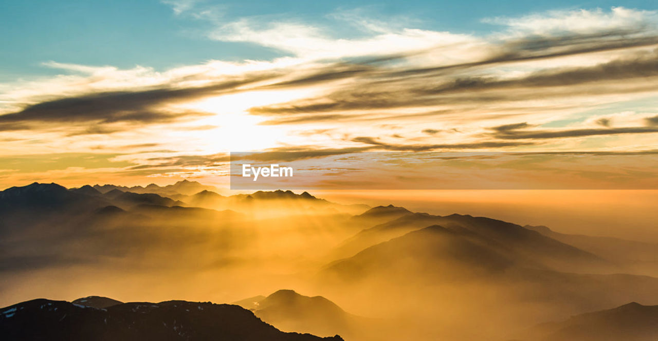 Scenic view of mountains against sky during sunset