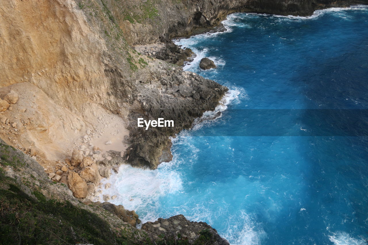 High angle view of cliff by sea