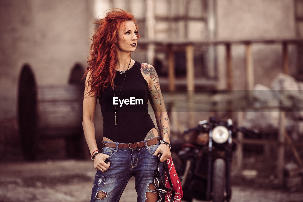 Redhead woman standing on road