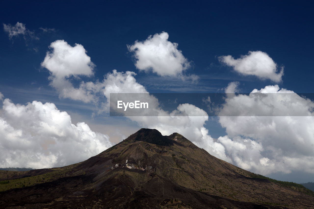 Scenic view of mountains against cloudy sky