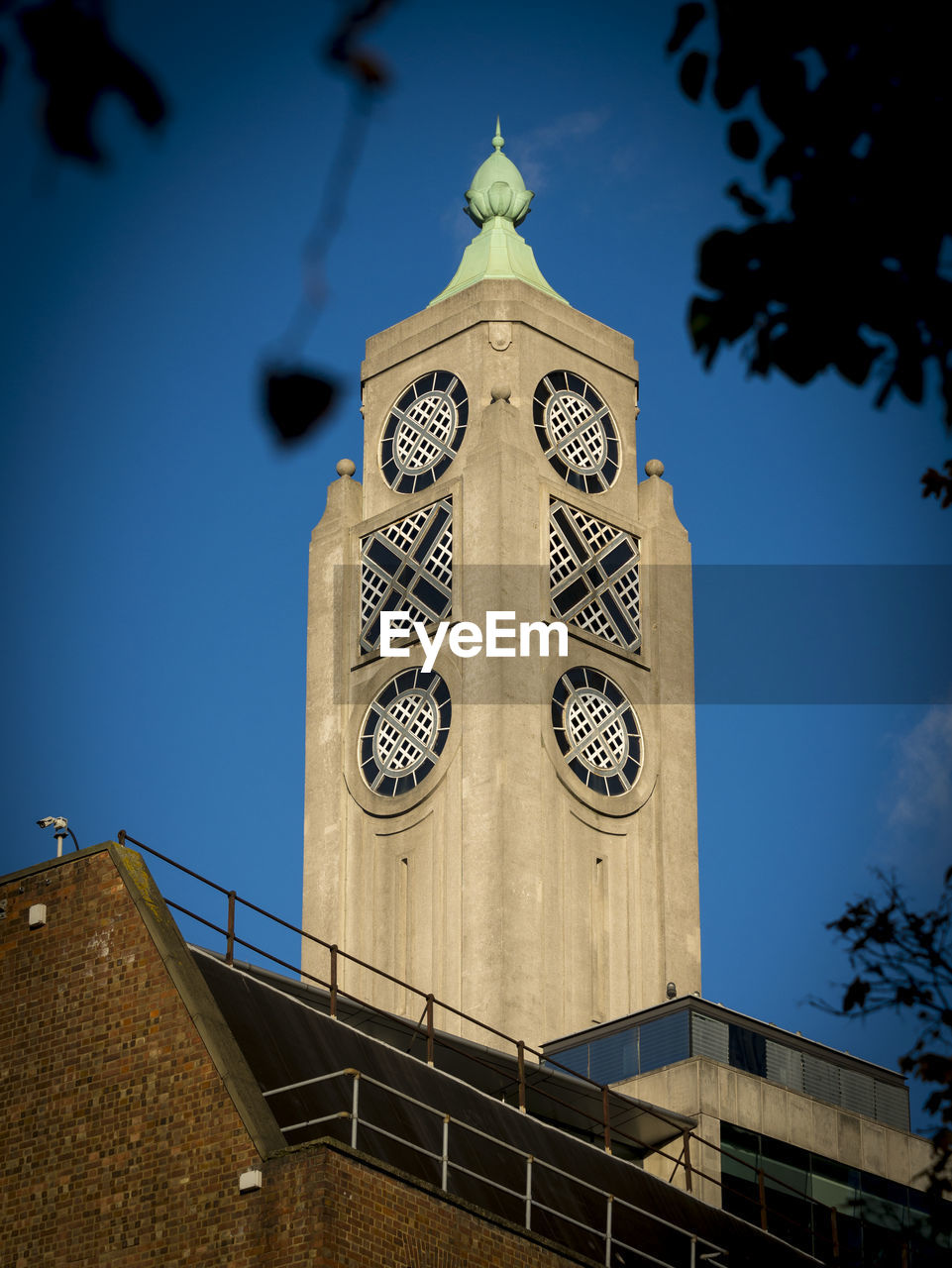 LOW ANGLE VIEW OF BELL TOWER AGAINST BUILDING