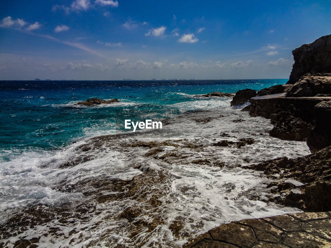 Scenic view of sea against blue sky