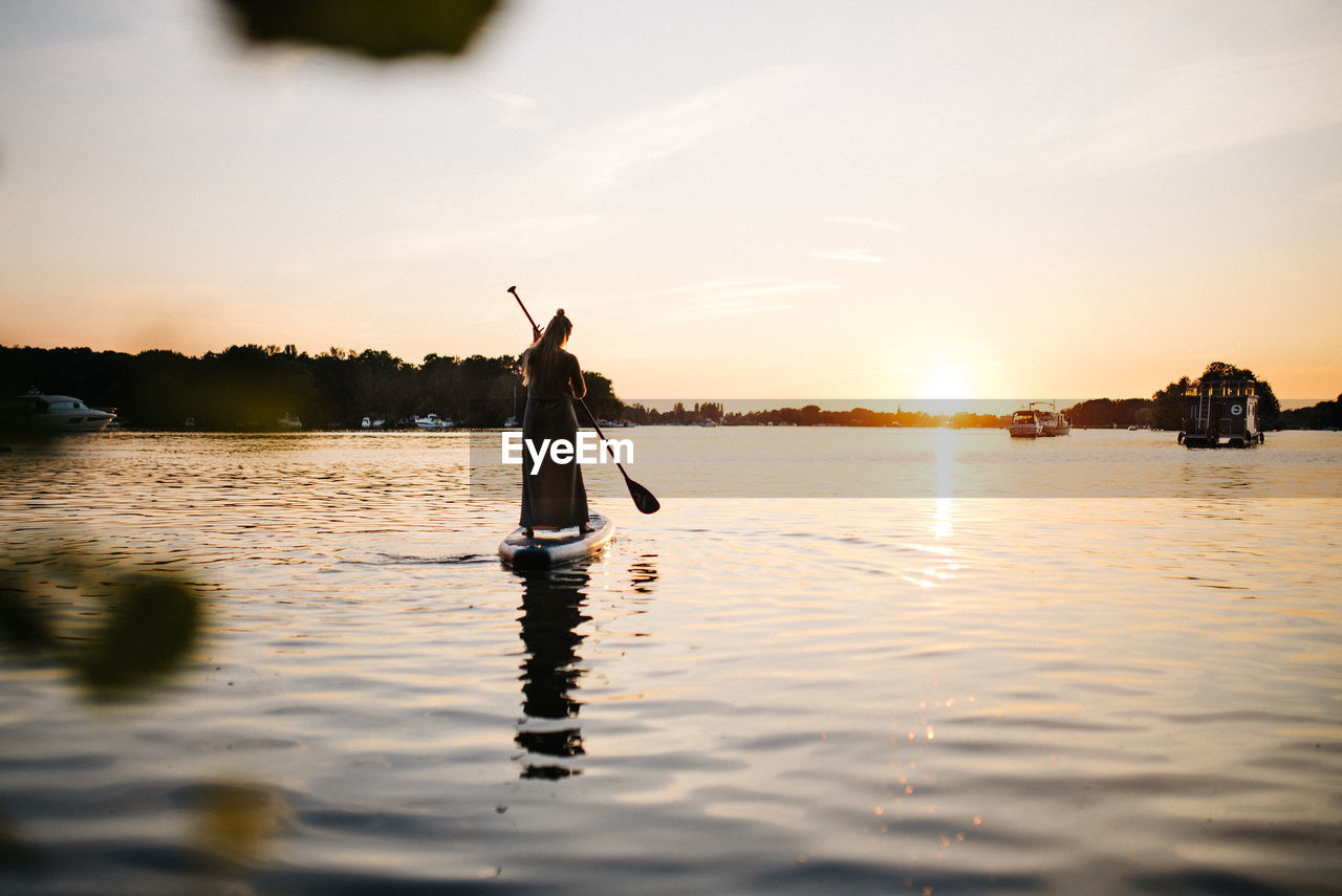 Silhouette of a women on a sup-board