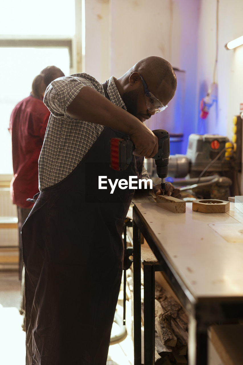 side view of man working at workshop