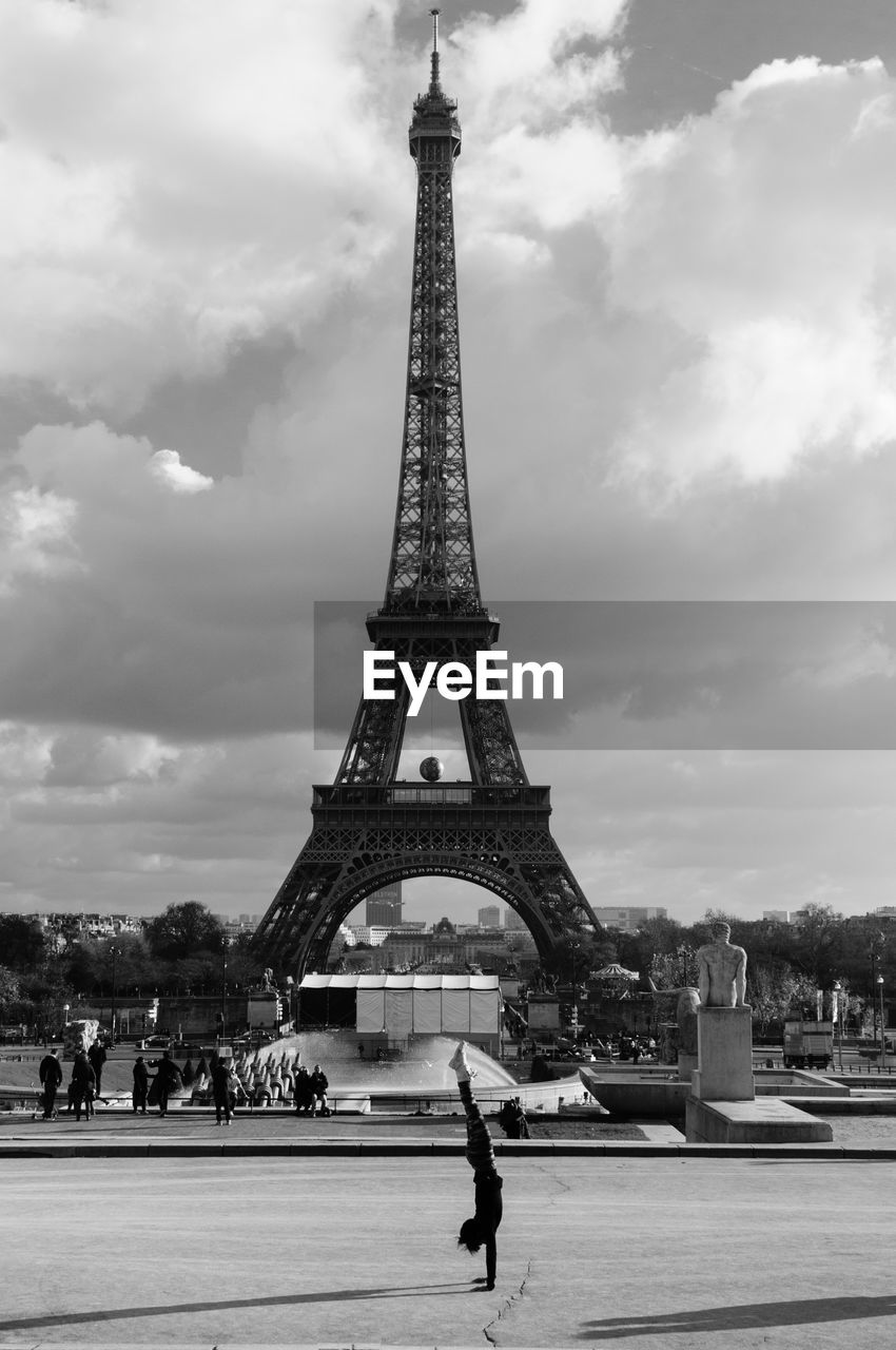 Eiffel tower against cloudy sky