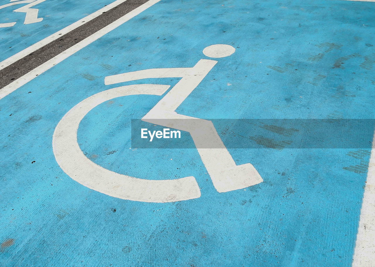 High angle view of wheelchair disabled sign on road