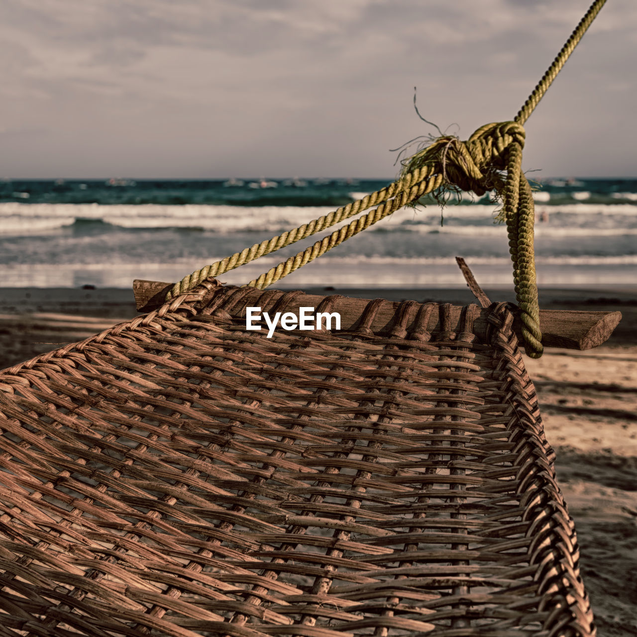 CLOSE-UP OF FISHING NET ON BEACH