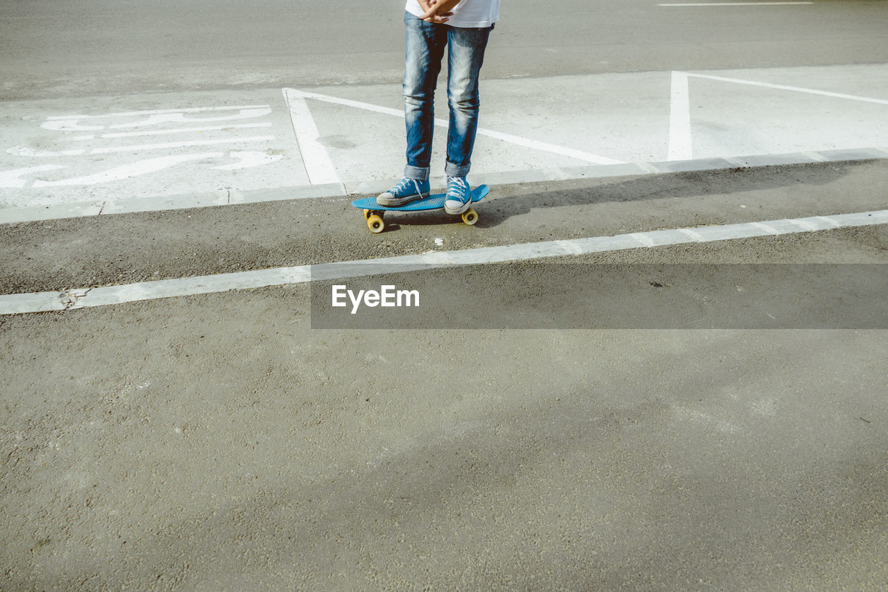 Low section of man skateboarding at park