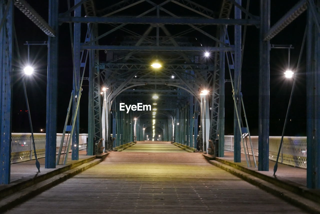 illuminated, the way forward, architecture, night, lighting equipment, built structure, diminishing perspective, light, street light, bridge, lighting, no people, transportation, urban area, street, vanishing point, footpath, city, empty, outdoors, infrastructure