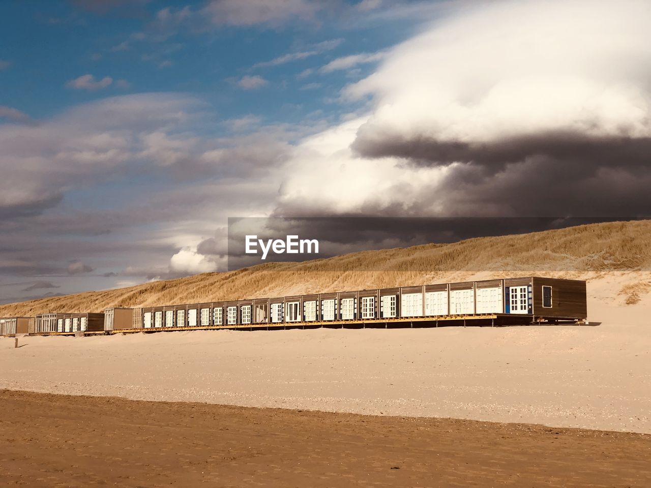 Scenic view of beach against sky. beachhouses. 