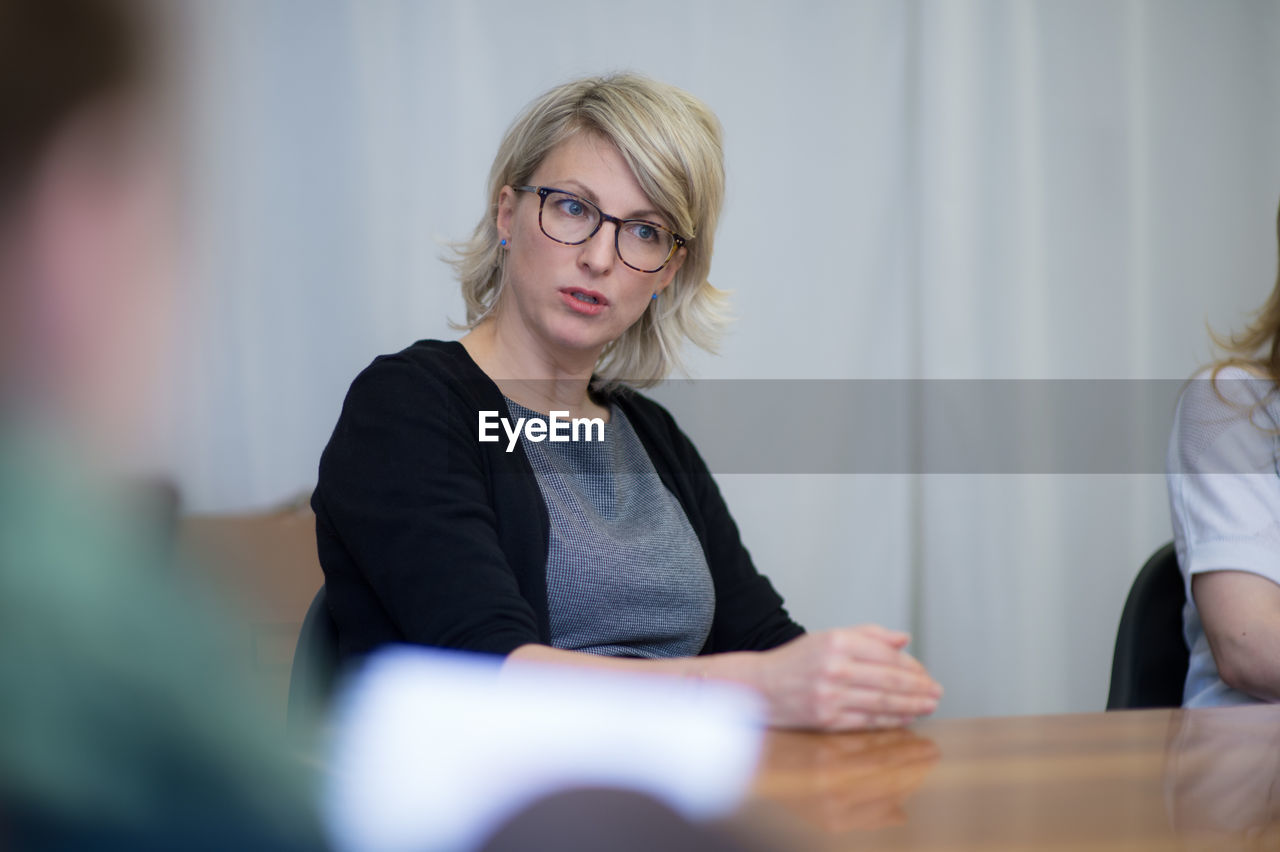 Beautiful businesswoman talking during meeting at conference room