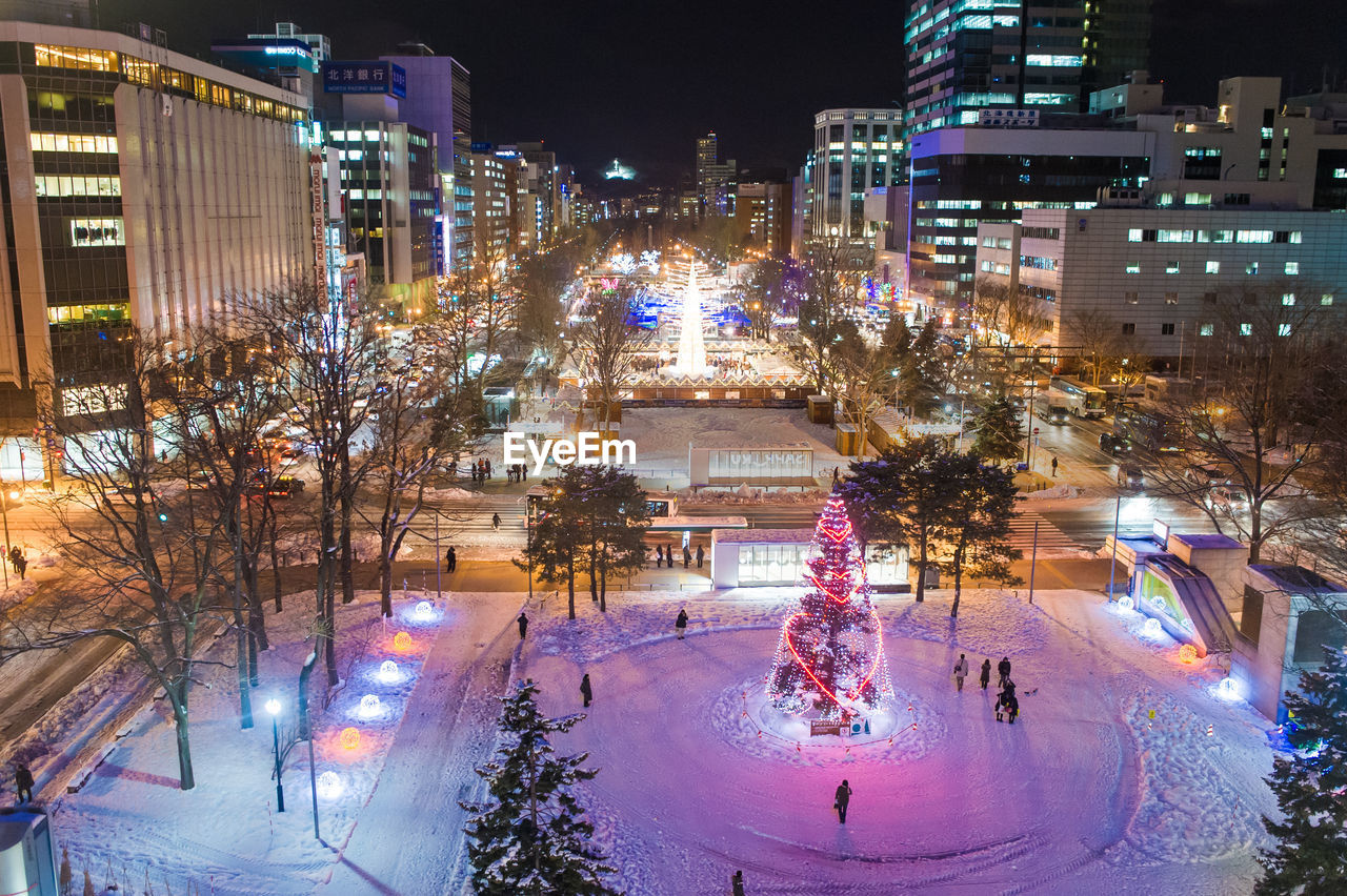 AERIAL VIEW OF ILLUMINATED CITYSCAPE