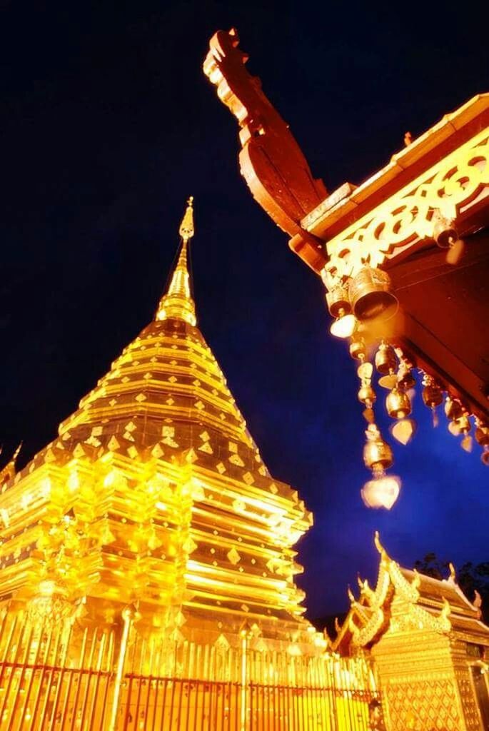 LOW ANGLE VIEW OF ILLUMINATED TEMPLE AT NIGHT