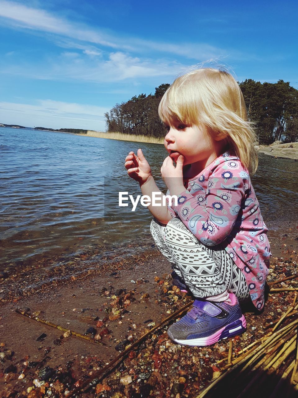 SIDE VIEW OF GIRL ON SHORE