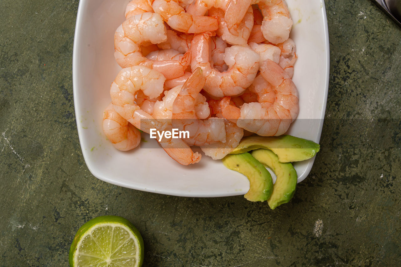 food and drink, food, shrimp, healthy eating, freshness, lemon, seafood, citrus fruit, lime, wellbeing, fish, fruit, dish, scampi, high angle view, no people, slice, produce, plate, animal, citrus, indoors, cuisine, crustacean, vegetable, table, directly above, still life, close-up