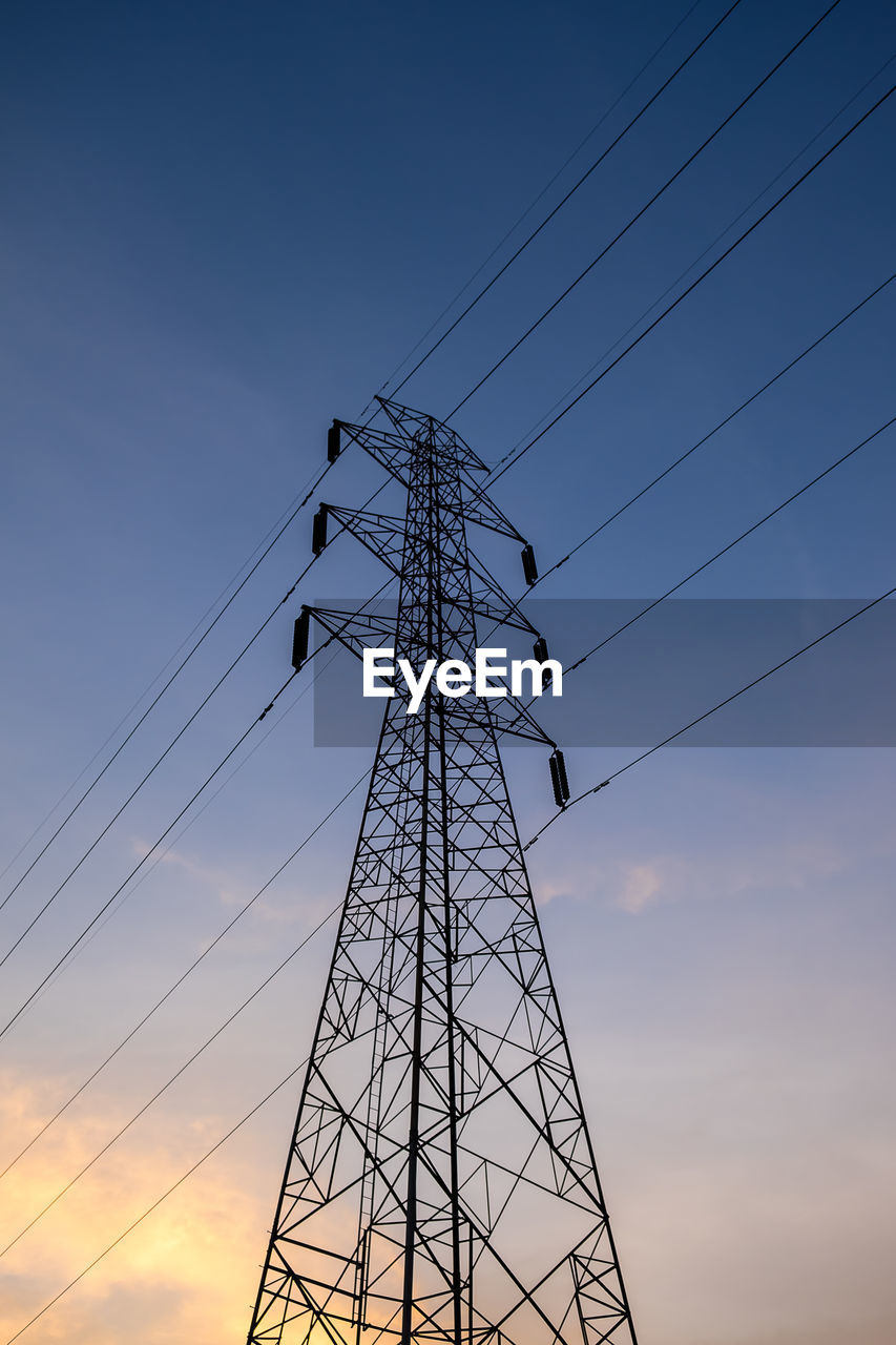 LOW ANGLE VIEW OF ELECTRICITY PYLON AGAINST SKY DURING SUNSET