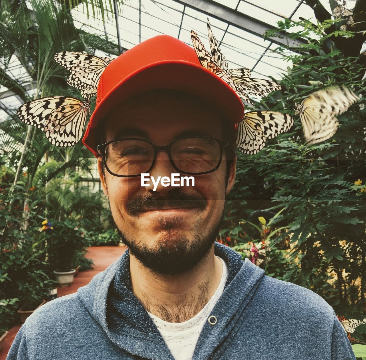 Portrait of mature man wearing sunglasses against plants