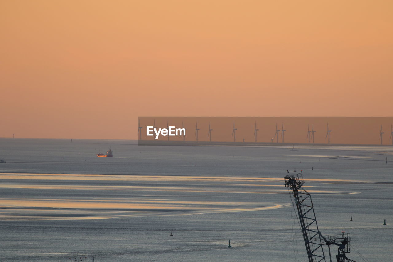 Scenic view of sea against clear sky during sunset