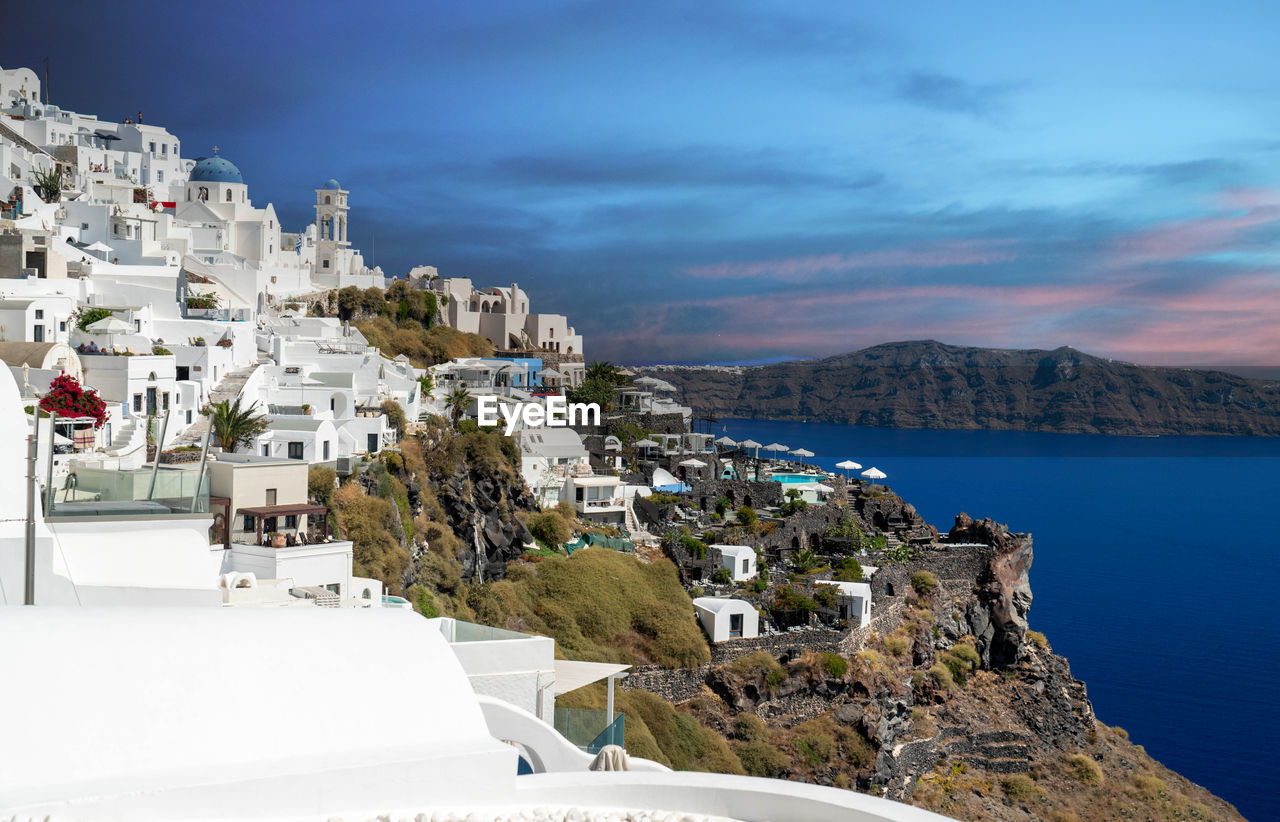 High angle view of townscape by sea against sky