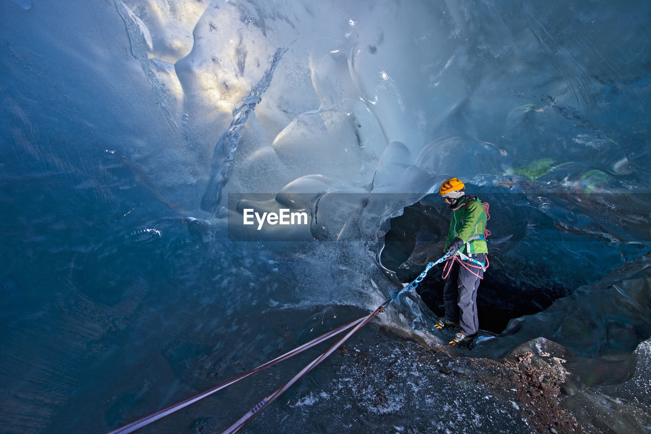 Woman exploring icecave on svinafellsjokull glacier