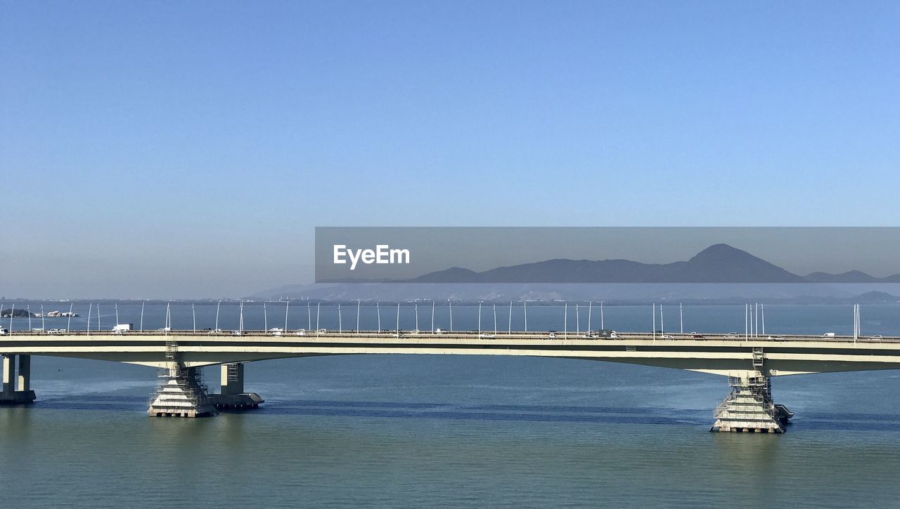 Scenic view of bridge over sea against clear sky