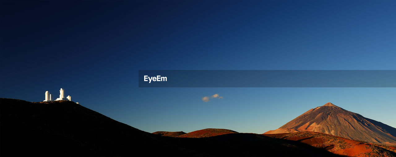 Scenic view of el teide volcano against clear blue sky