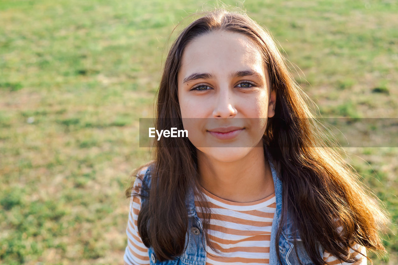 Portrait of a teenage girl in the golden rays of the autumn sun